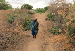 Saada Abdilahi walking long distance to access nearest water source in Beledweyne, Somalia.