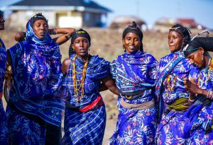 The women of Segei Machesa self help group sing in front of their newly constructed social hall.