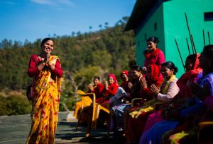 Pramila Bhul speaking to members of a Women’s Cooperative during its annual meeting.