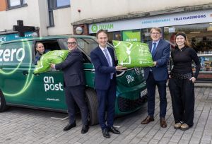 Jim Clarken, Oxfam Ireland CEO, An Post and Government representatives in front of an Oxfam shop in Ringsend, Dublin