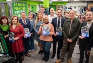 Oxfam staff in the Superstore shop in Holywood standing holding the GEM brochure