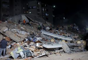 People and rescuers work on the debris from the Rita building after a magnitude 7.2 earthquake struck Venezuela and other regions in the Caribbean 