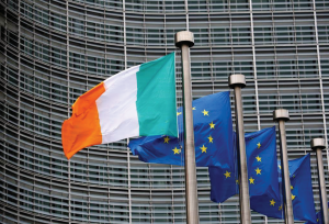 Irish flag beside three European Union flags.