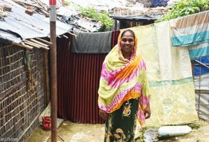 Smiling woman in front of her shelter
