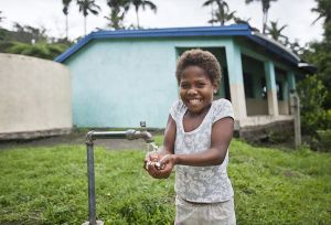 Child smiling washing hands