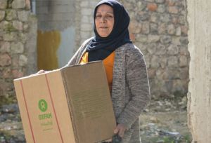 Woman carries a winter survival box