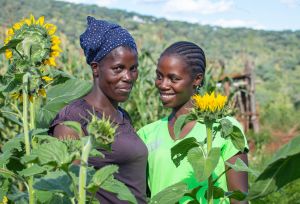 Beata Ndlovu and her mother in a sunflower field