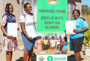 Young women in Zimbabwe holding certificates