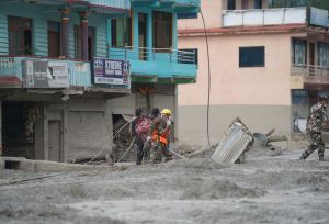 Two workers helping in flash floods in Nepal.