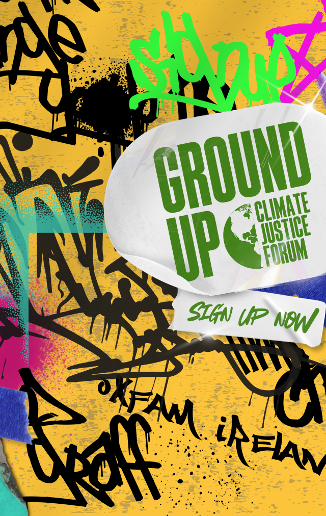A graffiti wall with a sticker in the middle with the Ground Up Climate Justice Forum logo and stickers saying Sign Up Now and University College Cork
