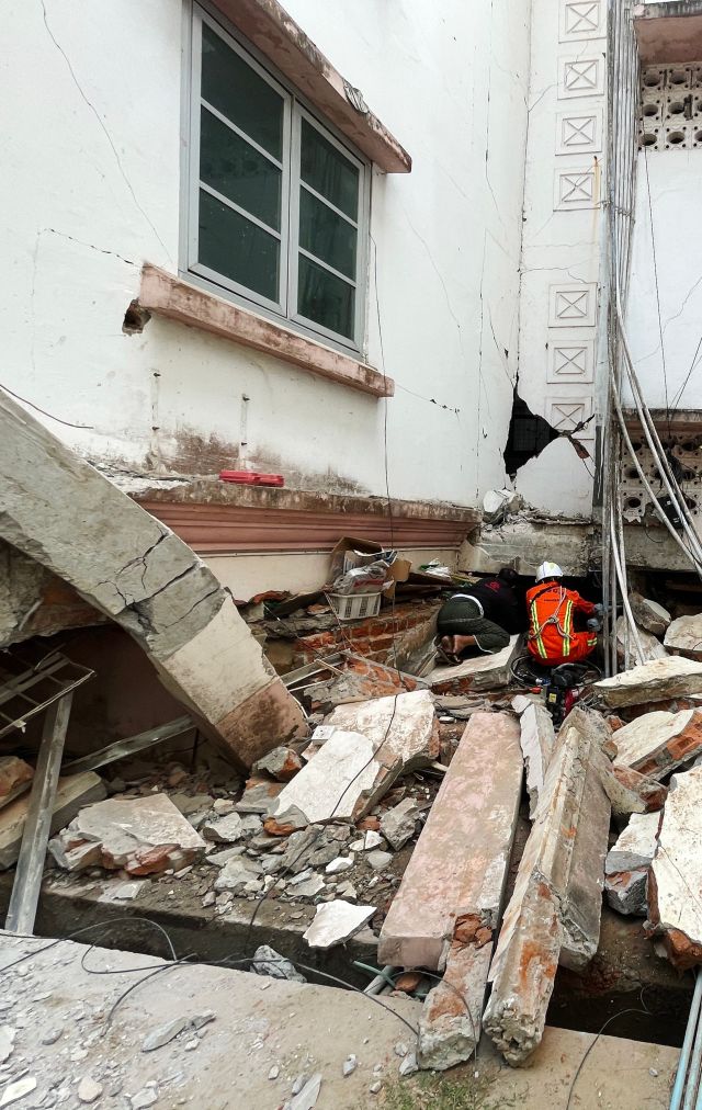 Rescuers search for survivors in damaged government staff housing buildings following an earthquake in Naypyidaw.