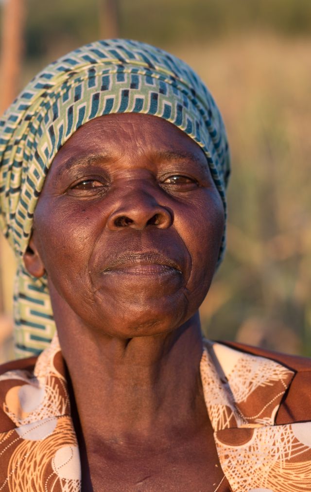 Fungai Nyikadzino, a farmer in Gutu, Zimbabwe, stands on her land affected by climate injustice and worsening droughts.