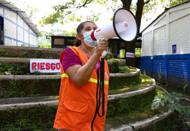 Woman using a megaphone. Voice your feedback or Complaints