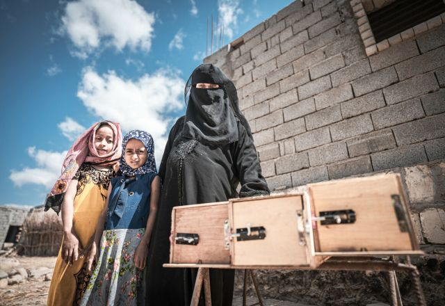 Nazrah Mohsen with her daughters and beehives