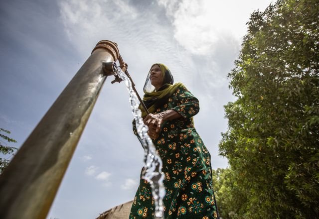 woman at water pump