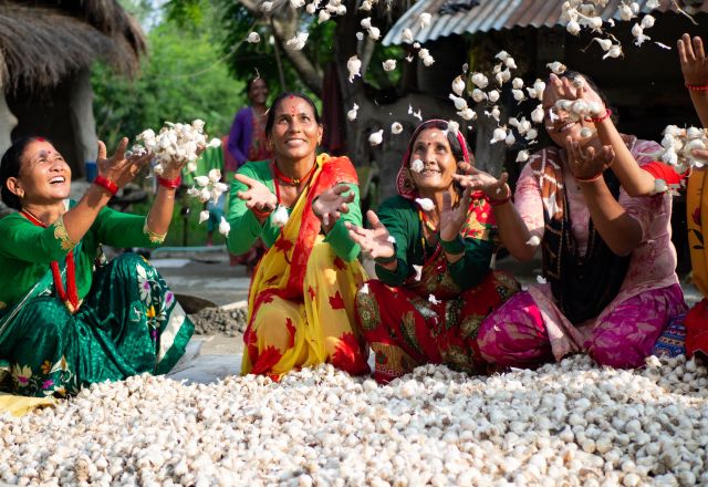 Members of a women’s group celebrate the success of their garlic project.