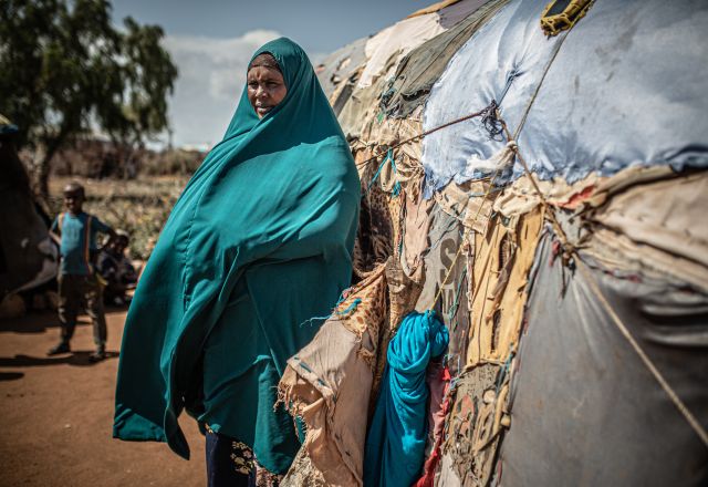 Hoden Abdi Iwal standing in front of her house.