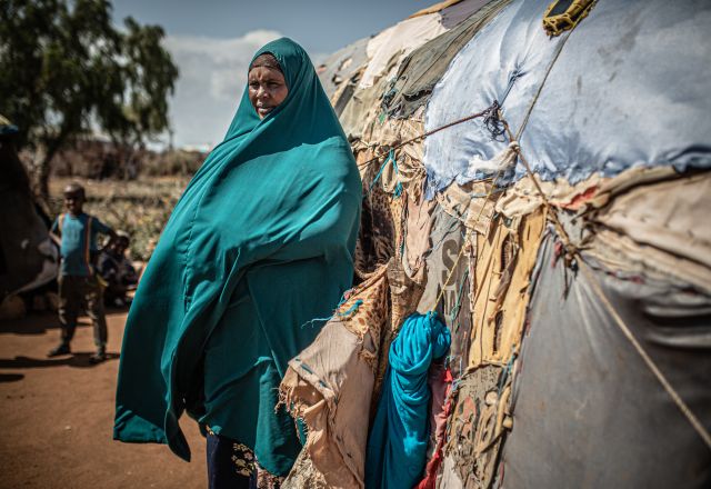 Hoden Abdi Iwal standing in front of her house. 