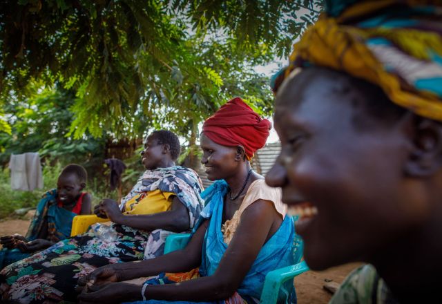 42-year-old Nyawouw Mayok, a female leader at Gambella refugee camp, engages in a discussion with a group of women outside her house, addressing pertinent issues affecting women in the camp