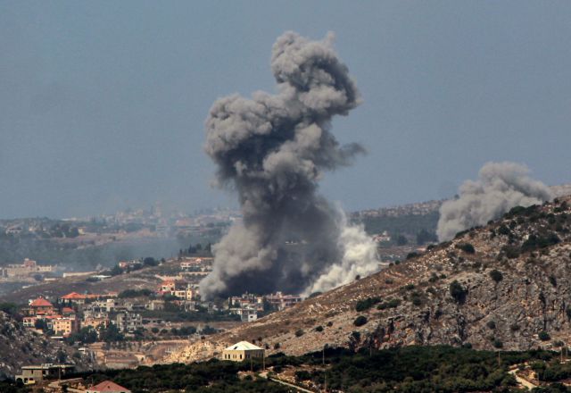 Israeli aerial bombardment on Lebanon. On the picture there is a cloud of smoke over a city in the distance.