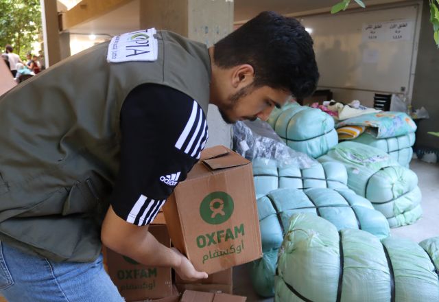 Oxfam's partner staff distributing hygiene management kits
