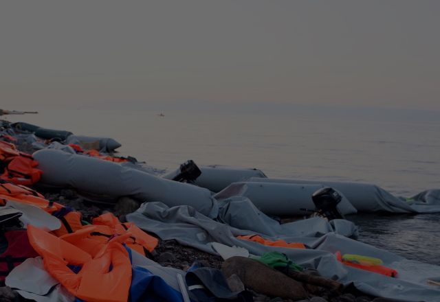 refugee dinghy boat washed off the coast