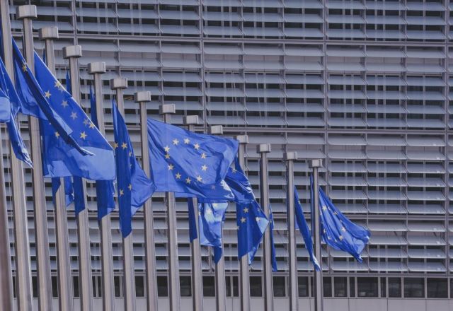 European Commission building with European flags in a row