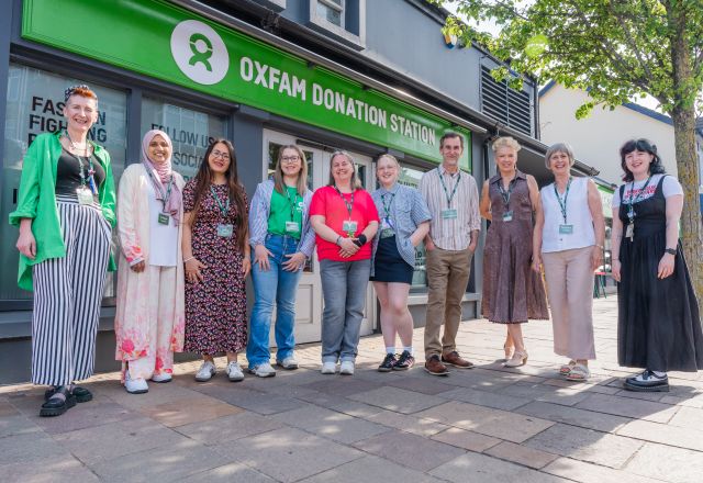 Group picture with staff and volunteers in front of the Oxfam Holywood superstore.