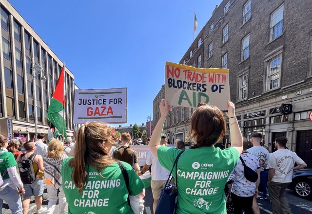Oxfam Campaigners at Dublin's national march for Palestine with banners "no trade with blockers of aid" and "Justice for Gaza"