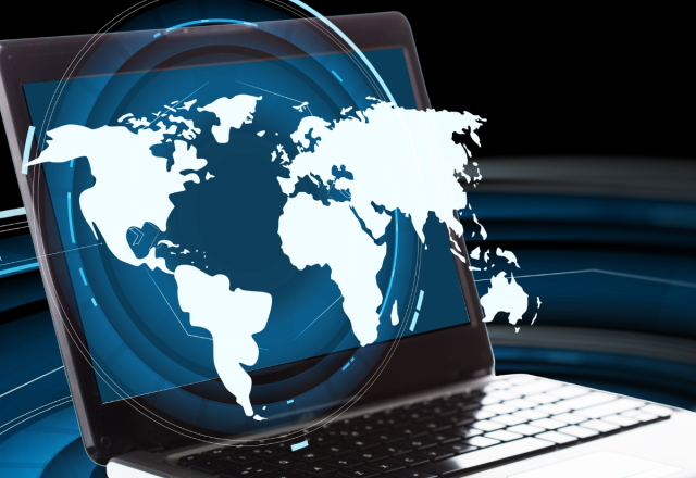 A world map coming out of a laptop, representing the Digital World concept.