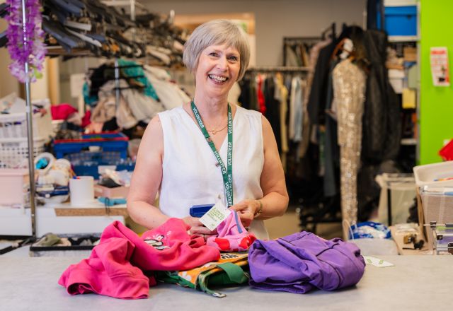 Barbara, a volunteer at Oxfam Holywood Superstore, sorting new donations.