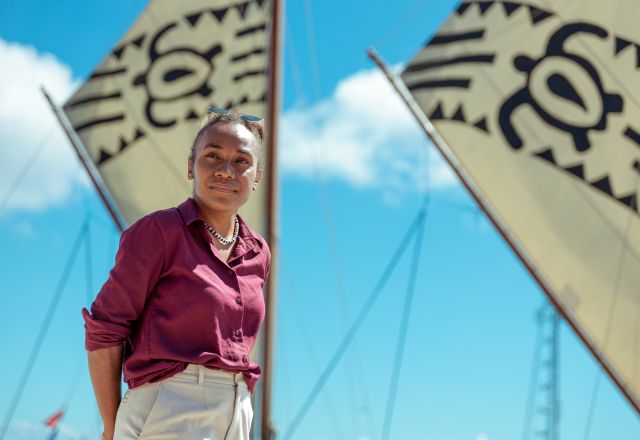 Cynthia Houniuhi stands in front of the Uto ni Yalo boat at the Pacific Island Forum in Tonga.