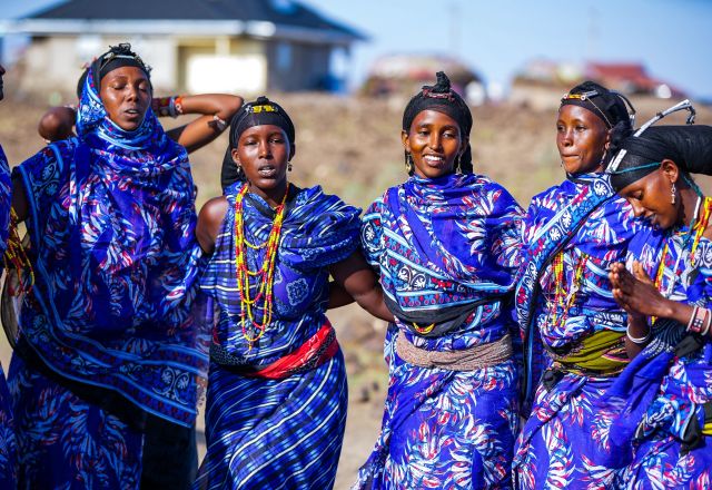 The women of Segei Machesa self help group sing in front of their newly constructed social hall.
