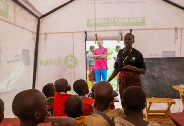 Adome Mary teaching kids at the mobile learning center