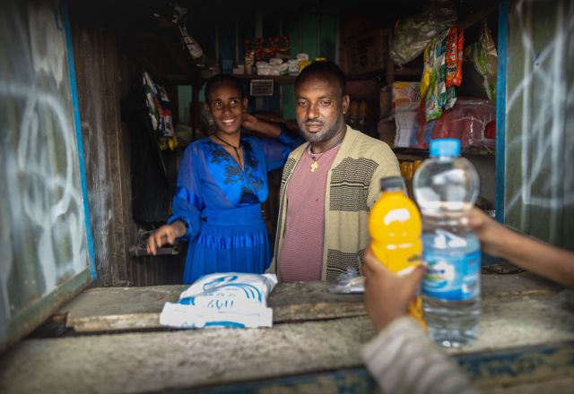 Simegn Hailu and her husband behind the counter of their small business