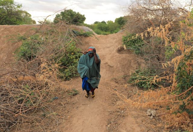 Saada Abdilahi walking long distance to access nearest water source in Beledweyne, Somalia.