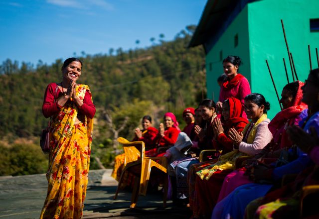 Pramila Bhul speaking to members of a Women’s Cooperative during its annual meeting.