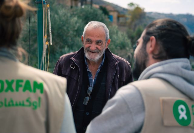 Oxfam staff having a conversation with Awad, Deir Mimas resident about the war and the water shortage.