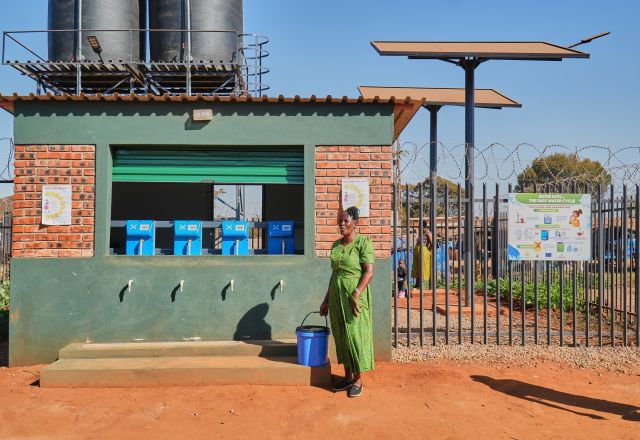 Tariro Zvirevo fetching clean water at an Oxfam water Kiosk in Kuwadzana.