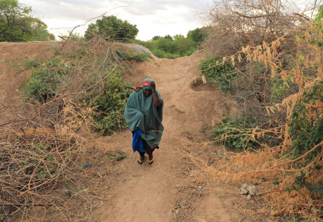 Saada Abdulahi carrying jerrycan of water.