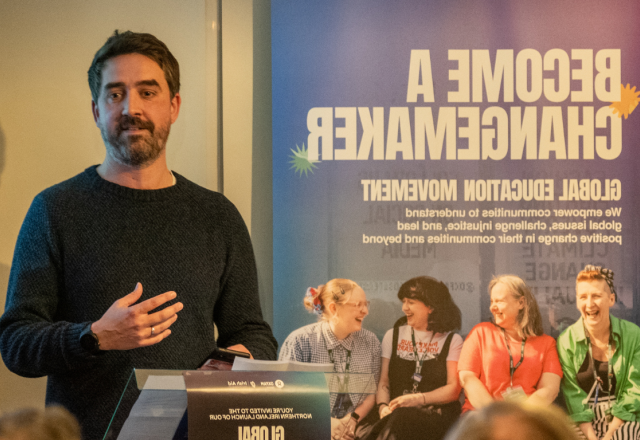 Dr Brendan Browne speaking in a podium in Oxfam event in Holywood County Down