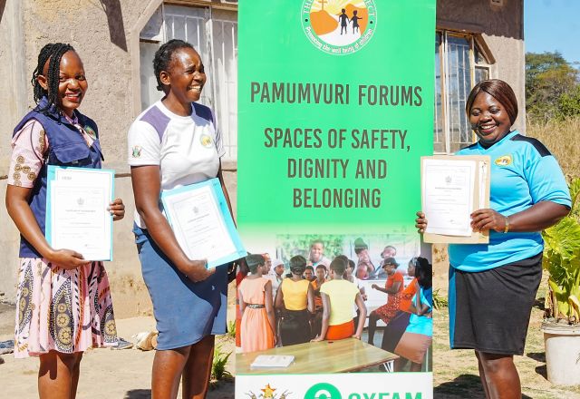Young women from Zimbabwe holding their certificates