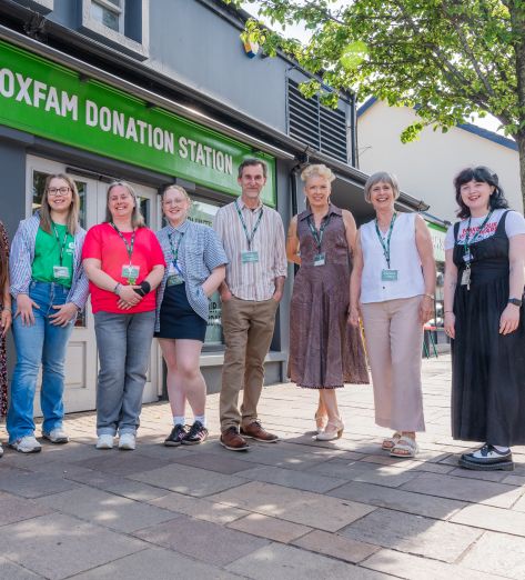 Group picture with staff and volunteers in front of the Oxfam Holywood superstore.