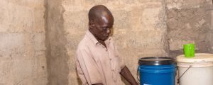Man in Zambia getting safe drinking water
