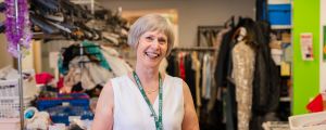 Barbara, a volunteer at Oxfam Holywood Superstore, sorting new donations.