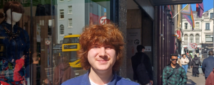 Marius, Volunteer standing at an Oxfam shop