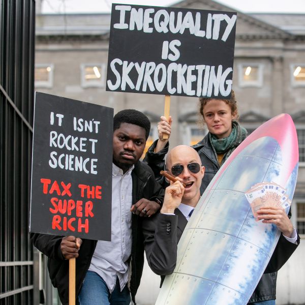 Stunt organised by Oxfam Ireland for the launch of their Wealth Inequality report. One of the sign reads "Inequality is skyrocketing" beside a man playing a billionaire look alike.