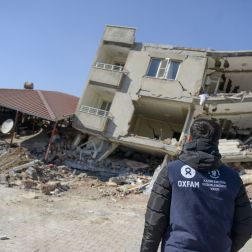 oxfam kedv staff looking at earthquake damage to building in Turkey