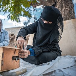 women building beehive