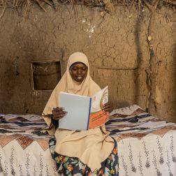 Zahara Reading a book with a smile